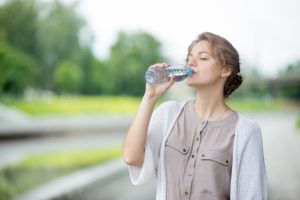 girl-drinking-water-with-blurred-background_1163-63