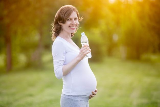 pregnant-woman-holding-a-bottle-of-water_1163-44