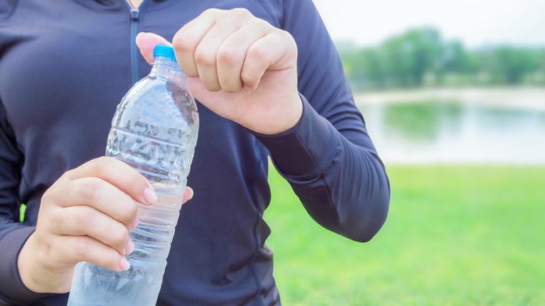 Close-up plastic water bottle in woman hand After Exercise; Shutterstock ID 644628346; Job: GSK